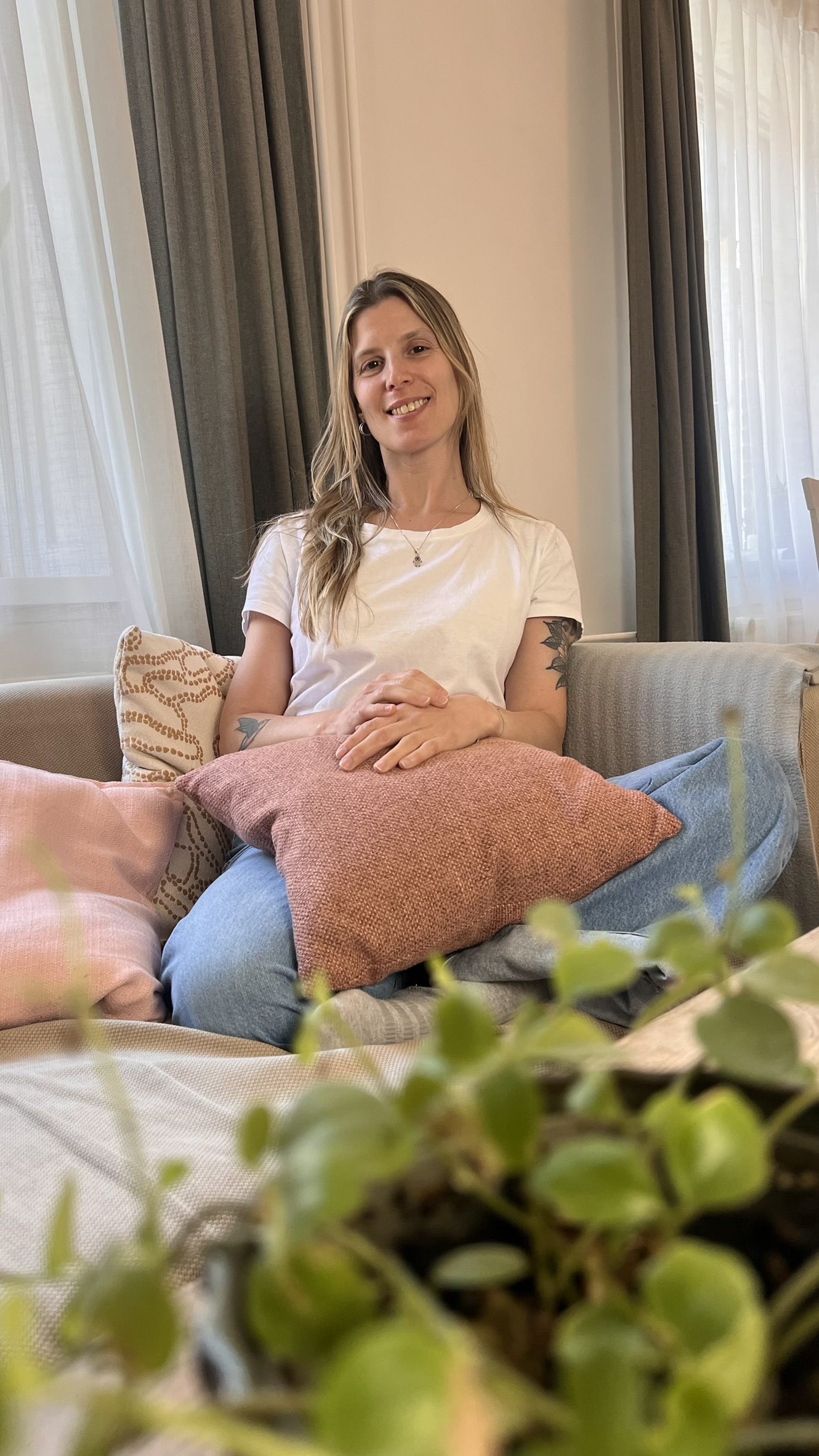 The ALMA DOULA doula sitting calmly on a sofa